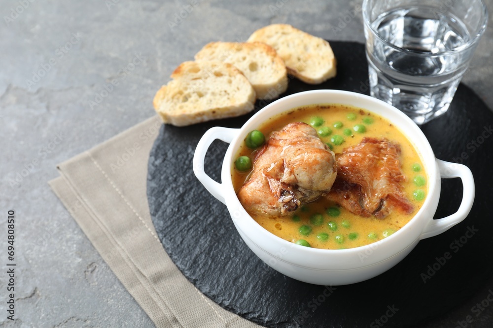 Tasty cooked rabbit meat with sauce served on grey table. Space for text Tasty cooked rabbit meat with sauce served on grey table. Space for text