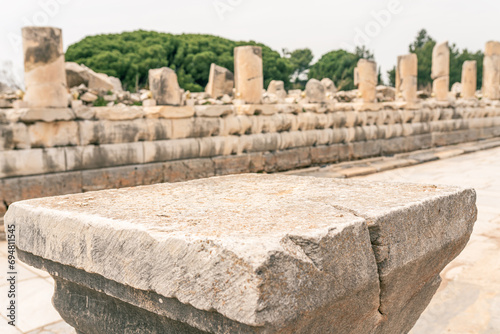 Marble stone podium with background of ancient ruins, empty product display floor platform, stage stand antique marble pedestal backdrop with natural marble show scene