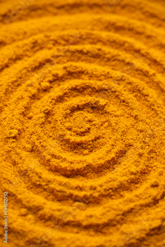 Heap of turmeric powder. Condiment or dietary supplement.