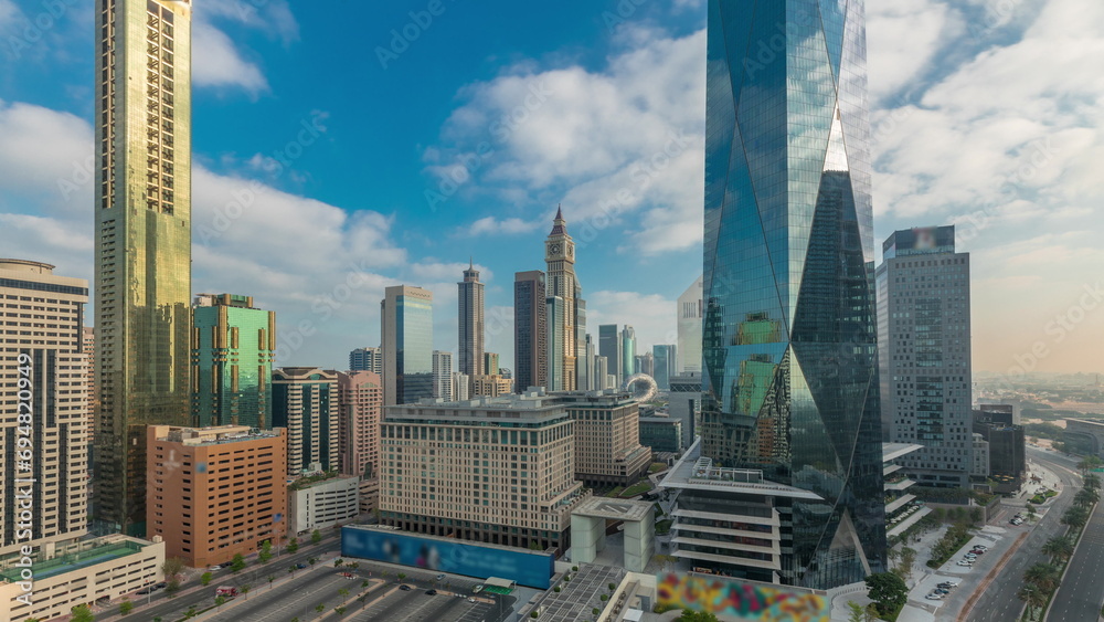 Fototapeta premium Dubai International Financial district aerial night to day timelapse. Panoramic view of business office towers.