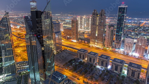 High-rise buildings on Sheikh Zayed Road in Dubai aerial night to day timelapse, UAE.