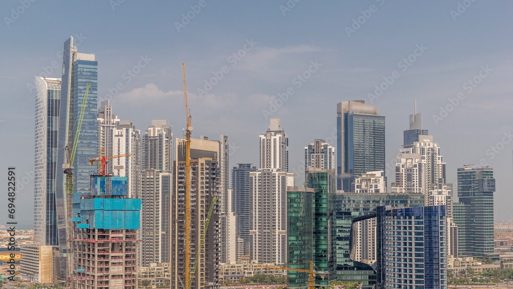 Obraz premium Cityscape with skyscrapers of Dubai Business Bay and water canal aerial timelapse.