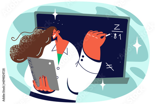 Female teacher writing on blackboard