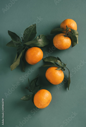 Oranges with Leaves on Cool Background photo