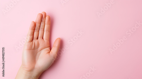 Female hand isolated on pink background.