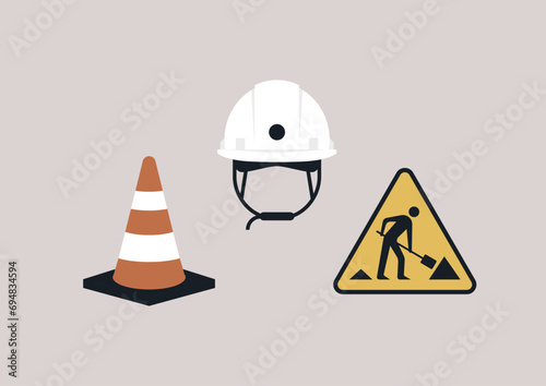 A set of construction tools arranged, featuring a white hard hat, an orange traffic cone, and a yellow caution sign depicting a silhouette holding a shovel