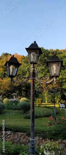 The lanterns placed in the park provide light and a beautiful, vintage look. photo