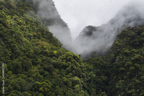 Mountains with green trees under cloudy sky in Thailand photo