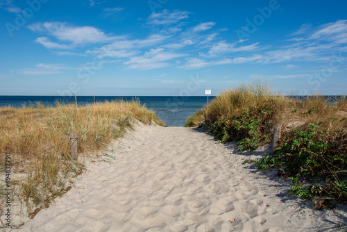 Path between the sand dunes overlooking the sea