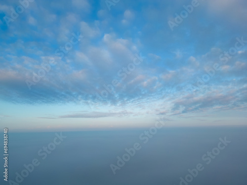 This photograph, taken with a drone above the mist, presents a breathtaking view akin to being above cloud level. The mist blankets the landscape, creating a seamless horizon where sky merges with the © Bjorn B