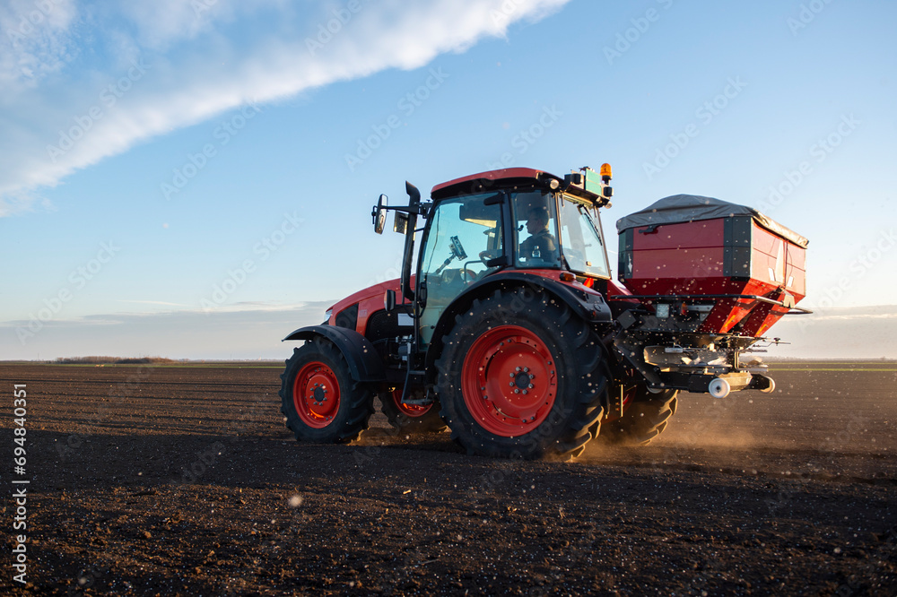 Tractor spreading artificial fertilizers Tractor spreading artificial fertilizers