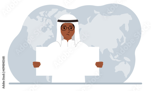The concept of world attention. A man holds a white poster in his hands against the background of a world map.