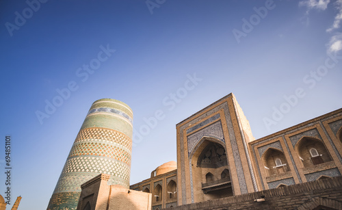 The Kalta Minar and Madrasah of Muhammad Amin Khan is lined with mosaics and ceramic tiles in the ancient city of Khiva in Khorezm, medieval architecture photo