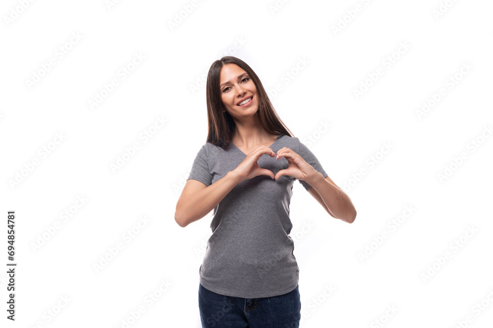 young kind smiling slender brunette promoter woman dressed in a gray t-shirt with space for print on a white background young kind smiling slender brunette promoter woman dressed in a gray t-shirt with space for print on a white background