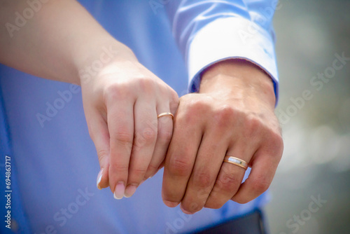 hands of married man and woman with rings photo