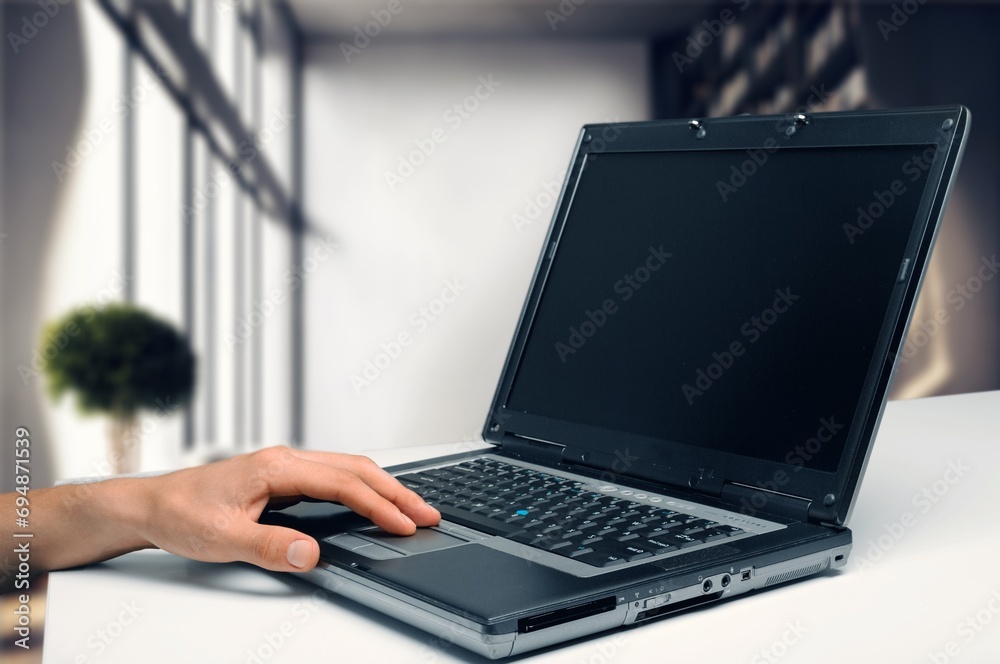 Business worker using laptop in office Business worker using laptop in office