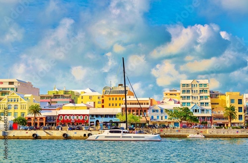 Catamaran passing pastel coloured buildings on Front Street, Hamilton, Bermuda, Atlantic photo