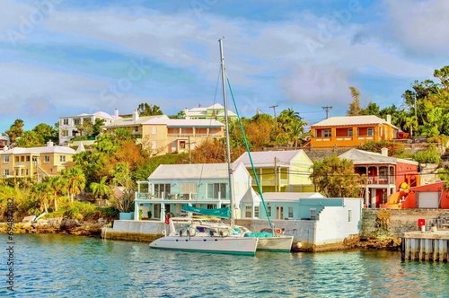 Catamaran in The Great Sound, moored in front of typical pastel coloured properties, Bermuda, Atlantic photo