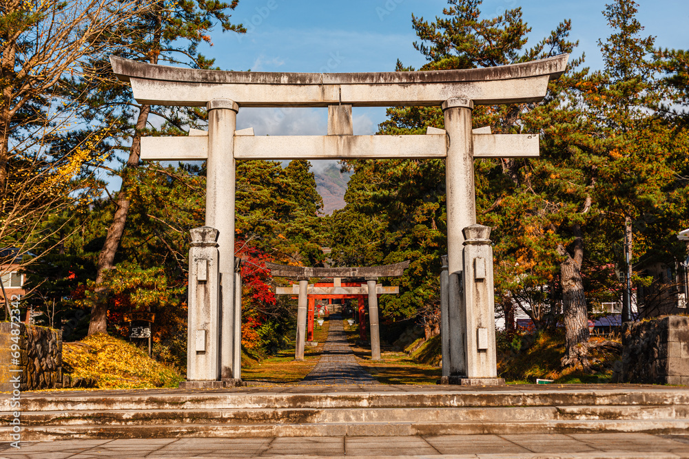 Big stone torii gate framing more distant gates on the foot of mount Iwaki. Iwakiyama-jinja Shrine Mt Iwaki Shrine in Hirosaki, Japan Big stone torii gate framing more distant gates on the foot of mount Iwaki. Iwakiyama-jinja Shrine Mt Iwaki Shrine in Hirosaki, Japan