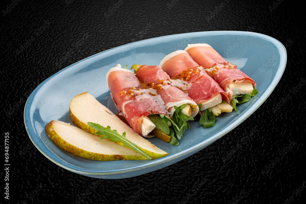 Hamon rolls filled with brie cheese and pear. Isolated image Hamon rolls filled with brie cheese and pear. Isolated image