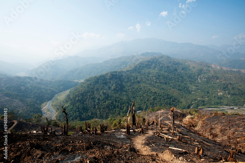 Green Naga hills stretching into the distance, scarred by brown scorched hill after slash and burn system has occurred, Nagaland, India photo