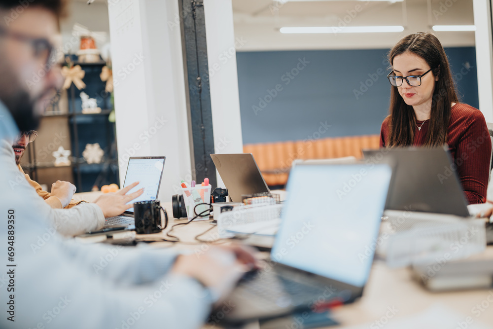 Multiracial business team collaborating on financial reports and planning business strategy. Multiracial business team collaborating on financial reports and planning business strategy.