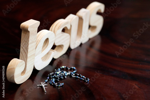 Wooden letters forming the word JESUS and Rosary, Christian symbol, Vietnam, Indochina photo