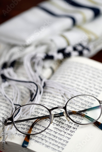 Open Torah, tallit and pair of glasses, France photo
