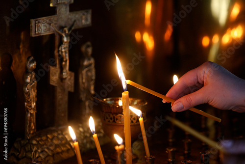 Faithful lighting a candle in Saint Teaodor Tiron (Ciuflea) Cathedral and Monastery, Chisinau, Moldova photo