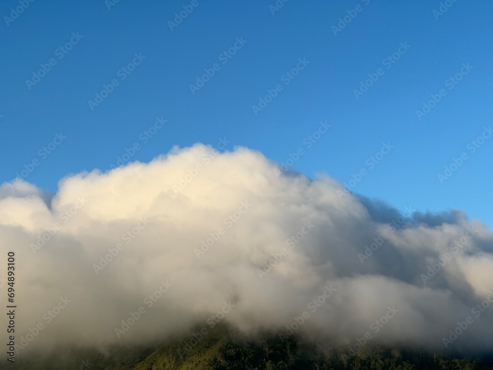 Fog covered the mountain top in the morning.