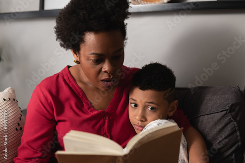 Mother with son read book in home room