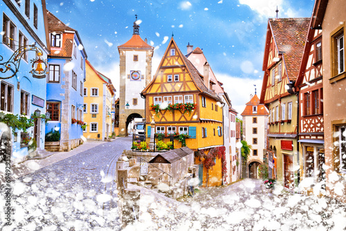 Cobbled street and architecture of historic town of Rothenburg ob der Tauber winter snow view photo