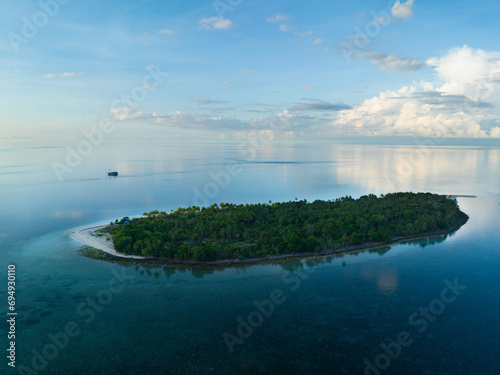 Early morning light illuminates the remote island of Koon near Seram, Indonesia. This scenic island's coral reefs, and the surrounding seas, support extraordinary marine biodiversity.