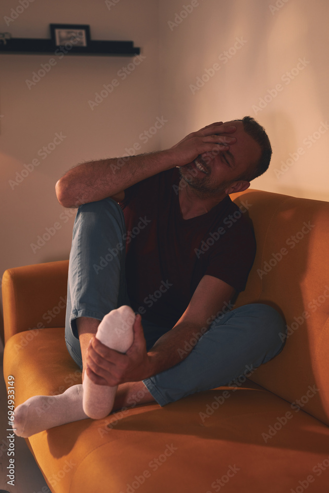 Man with foot pain at home. Man with foot pain at home.