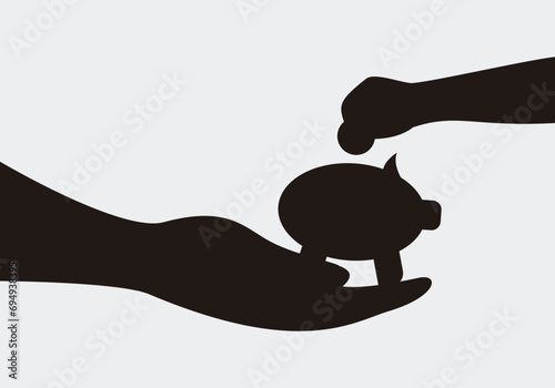 Educación financiera de padres a hijos. Enseñar a ahorrar. Un padre ofreciendo a su hijo una hucha para que introduzca monedas y ahorre