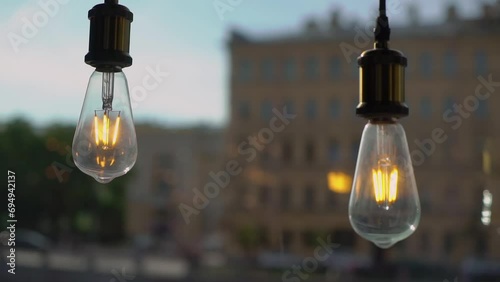Edison lamps with tungsten filament. Vintage antique decorative light bulbs hang from the ceiling. Interior decoration, event or wedding reception or ceremony. photo