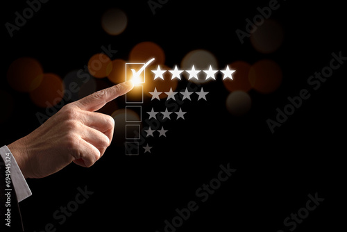 Businessman hand  give five star symbol to increase rating of products and service on the virtual touch screen, Customer service and business satisfaction survey.