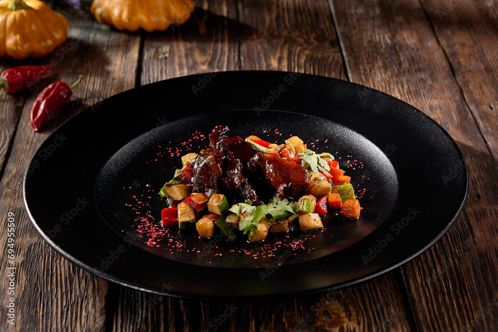 Braised beef cheeks with a vibrant vegetable ratatouille, served on a rustic black plate, autumn harvest-inspired Braised beef cheeks with a vibrant vegetable ratatouille, served on a rustic black plate, autumn harvest-inspired