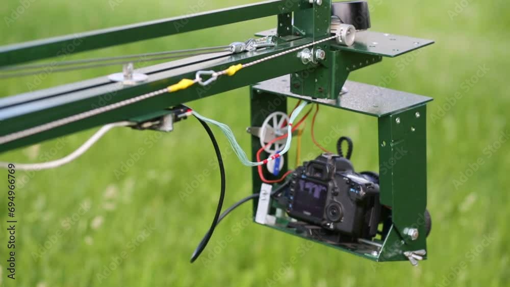 Head of homemade crane with camera moves outdoors Head of homemade crane with camera moves outdoors