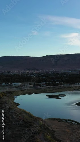 El Calafate City in Patagonia, Argentina in Summer. Mountains and Lake. Aerial View. Drone Flies Sideways and Upwards. Vertical Video photo