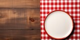 A plain plate against a checkered cloth, suggesting a home meal