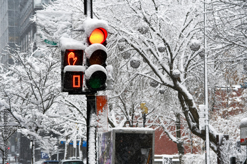 Traffic light turns red in downtown Montreal during a winter storm