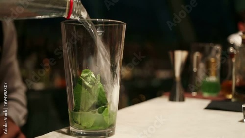 Hands of barmen mixing cocktail with mint in restaurant  photo