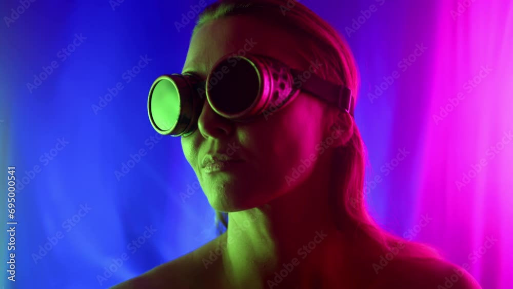 Cyberpunk style. A girl in glasses dances in a neon space with beautiful light rays, with pink and green light shining on her face. High quality 4k footage Cyberpunk style. A girl in glasses dances in a neon space with beautiful light rays, with pink and green light shining on her face. High quality 4k footage