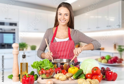 Young woman cooking food at home