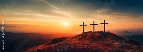 Crucifixion Of Jesus Christ At Sunrise three christian cross es on top of a Hill at sunset, easter and christian concept, horizontal background, copy space for text