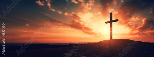 Crucifixion Of Jesus Christ At Sunrise -a christian cross on top of a Hill at sunset, easter and christian concept, horizontal background, copy space for text photo