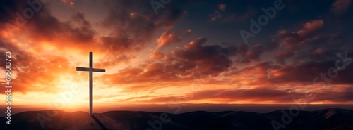 Crucifixion Of Jesus Christ At Sunrise -a christian cross on top of a Hill at sunset, easter and christian concept, horizontal background, copy space for text © XC Stock