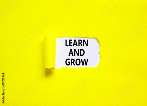 Learn and grow symbol. Concept word Learn And Grow on beautiful white paper. Beautiful yellow table yellow background. Business, education learn and grow concept. Copy space.