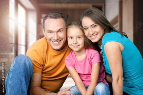 Mom, dad and small child have fun at home
